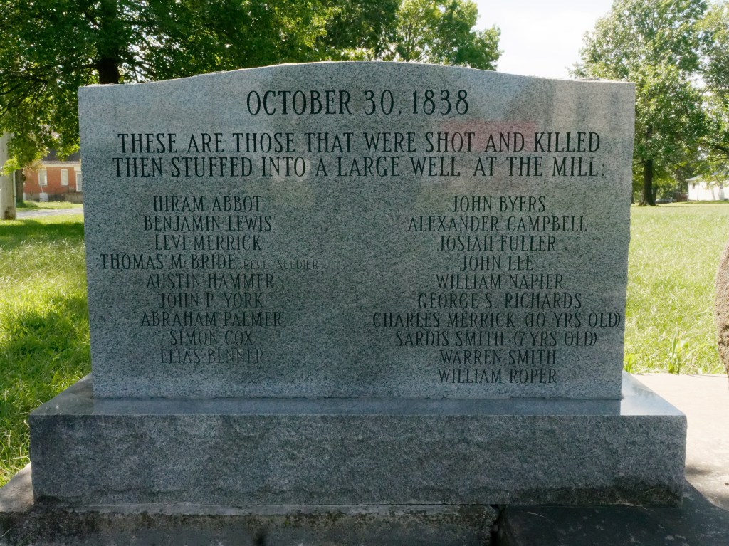 Memorial stone that reads "Oct 30, 1838 These are those that were shot and killed then stuffed into a large well at the mill."  A list of 19 names follows.