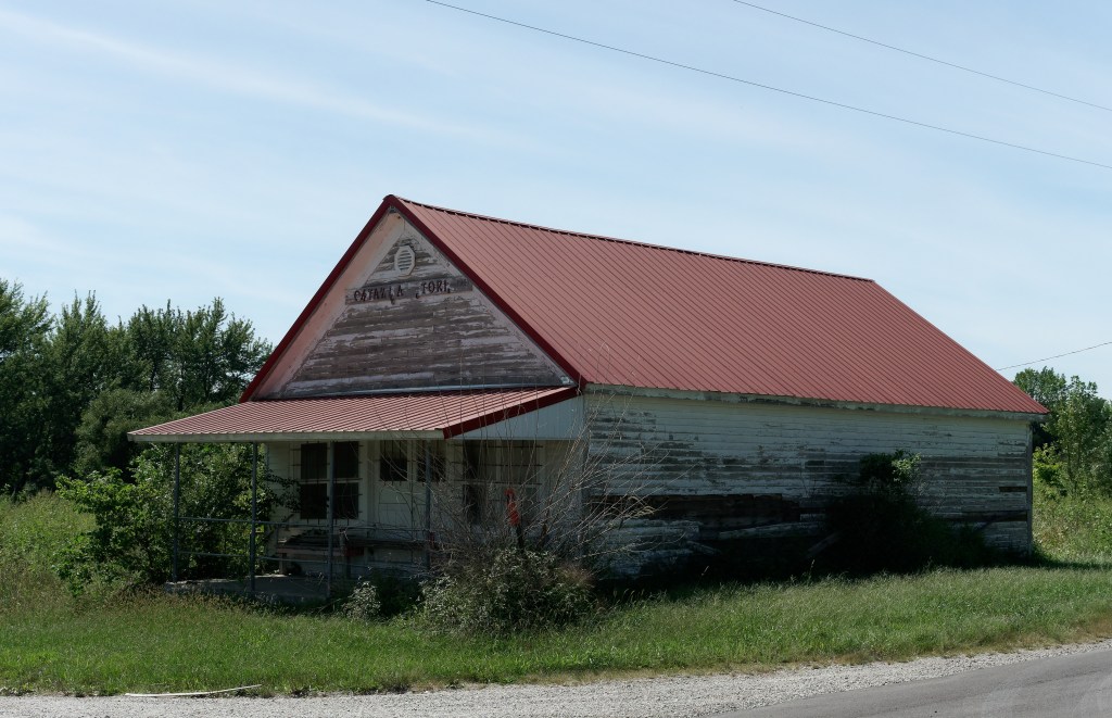 An abandoned building with a sign that (apparently) reads Catawba Store est 1927.  Several letters are missing.